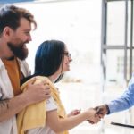 couple shaking hands with a realtor