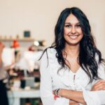middle-aged woman smiling while crossing arms
